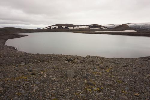 A clear lake at the bottom of the Sléttjökull. You’ll see the top of the Mælifell in the background (distance is about 10 km / 6 mi).