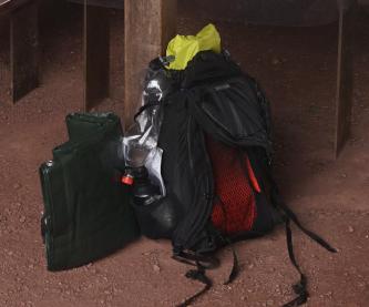 My backpack with two water bottles, waterproof bag and tarp on the left.